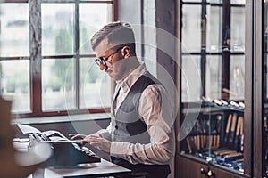 Young writer typing on a retro typewriter