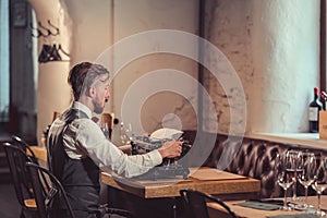 Young writer typing on a retro typewriter