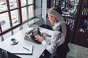 Young writer typing on a retro typewriter