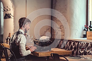 Young writer typing on a typewriter