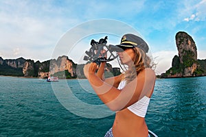 Young yacht captain measure boat position by navigational sextant