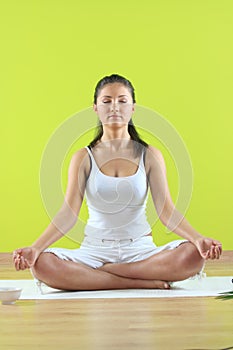 Young yoga female doing yogatic exericise photo