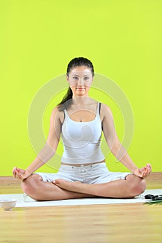Young yoga female doing yogatic exericise photo