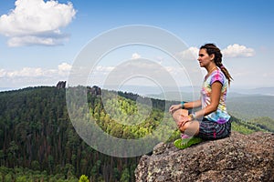 Young yoga woman sit meditation on mountain peak