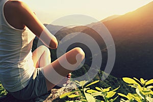 Young yoga woman sit on meditation mountain peak