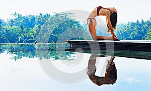 Young yoga woman stretching back in ustrasana camel pose