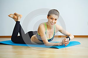 Young yogi attractive woman practicing yoga concept, wearing sportswear, black tank top and pants, full length, white loft