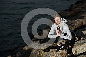 Young yogi rests his hands in a Namaste greeting position while freeing his mind from worries