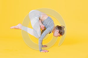 Young yogini woman doing crow pose