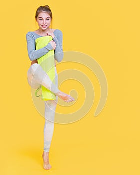 Young yogini woman before yoga glass