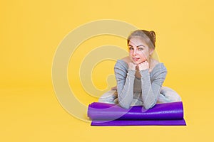 Young yogini woman before yoga glass