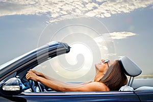 Young girl driving convertible photo