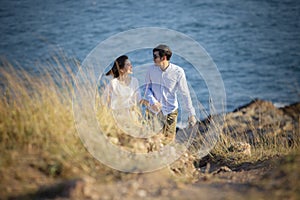 Younger asian man and woman relaxing at vacation  sea beach