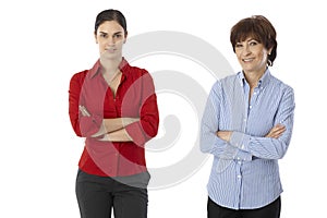 Younger and older woman standing arms crossed