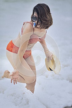 Younger woman wearing bikini suit playing with happiness emotion on summer vacation beach