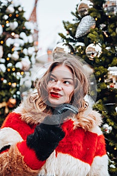 Younggirl on the red Square through winter holiday in Moscow, stylish and beautiful posing near to Christmas tree