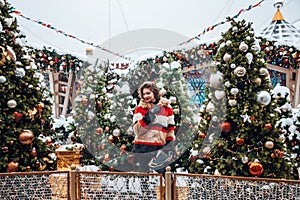 Younggirl on the red Square through winter holiday in Moscow, stylish and beautiful posing near to Christmas tree