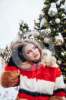 Younggirl on the red Square through winter holiday in Moscow, stylish and beautiful posing near to Christmas tree