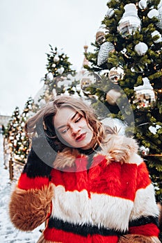 Younggirl on the red Square through winter holiday in Moscow, stylish and beautiful posing near to Christmas tree