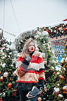 Younggirl on the red Square through winter holiday in Moscow, stylish and beautiful posing near to Christmas tree