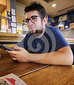 Youngman talking and typing a message at the same time photo