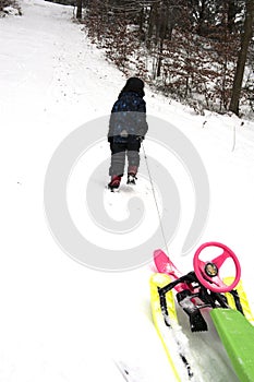 Youngster dragging a sledge