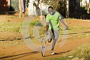 Youngster Playing with Wheel Rim