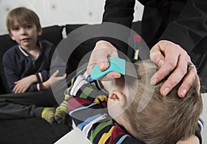 Youngsters getting head inspected for lice