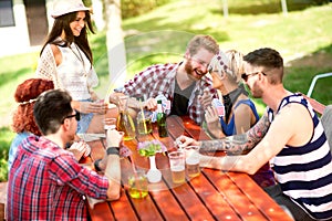 Youngsters play cards, laughing and joking in nature