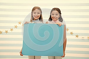 Your advertisement in good hands. Girls kids hold advertisement poster copy space. Children hold advertising banner