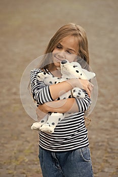 Because your baby deserves care. Happy child cuddle toy dog outdoors. Love and care. Play and development. Toy shop