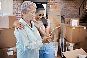 Your belongings might leave home but your heart never will. a senior woman looking at a photograph with her daughter