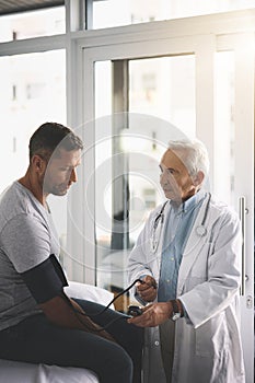 Your blood pressure is a little high. a senior doctor giving his male patient a thorough checkup during his consultation
