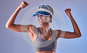 Your body is as strong as you decide it to be. Studio shot of a fit young woman flexing her muscles against a grey