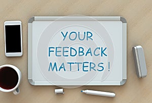 Your Feedback Matters, message on whiteboard, smart phone and coffee on table