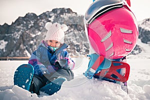 Your happy kid has ski or snowboard lesson at alpine school.