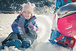 Your happy kid has ski or snowboard lesson at alpine school.