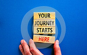 Your journey starts here symbol. Concept words Your journey starts here on wooden blocks on a beautiful blue table blue background