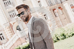 Your limitation - it`s only your imagination. Portrait of brown-haired man wearing sunglasses and looking away on the