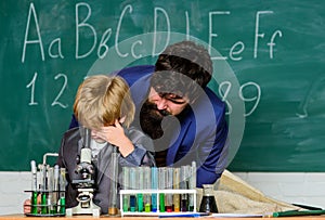 Your mind can think up great things. bearded man teacher with little boy. Back to school. Explaining biology to child