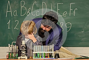 Your mind can think up great things. bearded man teacher with little boy. Back to school. Explaining biology to child