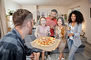 For your party. Excited multicultured friends ordered pizza while having karaoke party, singing with microphone in the