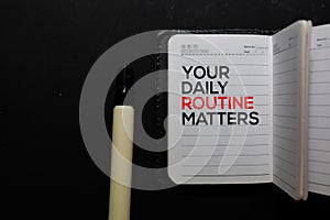 Your Daily Routine Matters. write on a book isolated on office desk photo