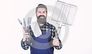 Your satisfaction guaranteed with cooking tool set. Happy hipster holding stainless steel tools. Bearded man with