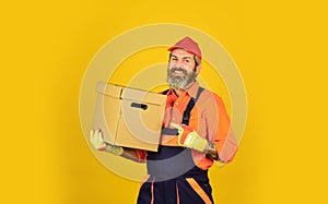 At your service. Moving house day. think outside the box. express delivery concept. Man worker in boilersuit hold box