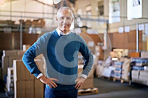 Your shipment is already on its way. Portrait of a mature man standing on the floor of a warehouse.