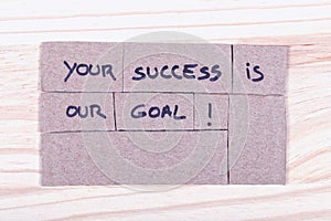 Your success is our goal! written with black felt-tip pen in cut