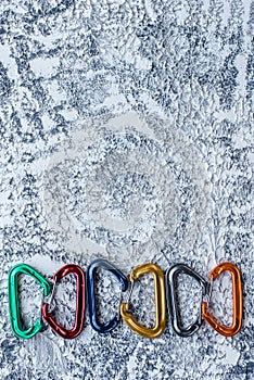 For your tastes. Isolated photo of climbing equipment. Part of carabiner lying on the white and grey colored surface