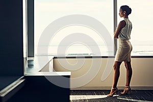 Your thoughts govern your future. Full length shot of an attractive young businesswoman posing with her arms folded