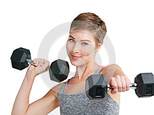 When your willower is as strong as your body. Studio portrait of a fit young woman working out with dumbbells against a